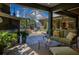 Inviting covered patio with outdoor seating area, overlooking a screened pool and lush landscaping at 115 Ellington Pl, Oviedo, FL 32765