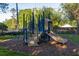 Community playground with climbing structure, slide, and soft ground covering for enjoyment at 115 Ellington Pl, Oviedo, FL 32765