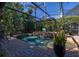 Gorgeous screened in pool with multiple fountains and manicured greenery at 115 Ellington Pl, Oviedo, FL 32765