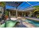 A screened in backyard pool and patio, perfect for outdoor entertaining and relaxation, plus tropical foliage at 115 Ellington Pl, Oviedo, FL 32765