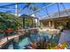 Covered outdoor pool area with a waterfall feature and tropical landscaping, creating a relaxing backyard retreat at 115 Ellington Pl, Oviedo, FL 32765