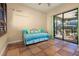 Bright sun room with tile flooring, a daybed, and large glass doors to the outside at 115 Ellington Pl, Oviedo, FL 32765