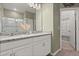 Bathroom featuring double sinks, granite countertops, and a glass-enclosed shower with a walk-in closet at 1174 Tupelo Trl, Haines City, FL 33844