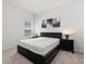 Modern bedroom featuring a sleek bed frame and stylish bedside lamps at 1174 Tupelo Trl, Haines City, FL 33844