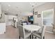 Open dining area near a modern kitchen with natural light and a view into the living space at 1174 Tupelo Trl, Haines City, FL 33844