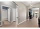 Hallway with tile flooring, leading to a bathroom, closet and living room with decorative wall at 1174 Tupelo Trl, Haines City, FL 33844