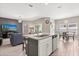 Open-concept kitchen featuring a large island with granite countertops and stainless steel appliances at 1174 Tupelo Trl, Haines City, FL 33844