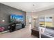 Cozy living room with a decorative wall, TV, fireplace, and sliding glass doors to the backyard at 1174 Tupelo Trl, Haines City, FL 33844