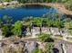 Stunning aerial view of home on a landscaped lot, with lake view, and a circular driveway at 1188 Brampton Pl, Lake Mary, FL 32746