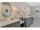 Bathroom with dual vanity sinks, custom mirrors, modern fixtures, and ample counter space at 1188 Brampton Pl, Lake Mary, FL 32746