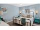 Comfortable bedroom features neutral walls, light curtains, a metal bed frame, and wood floors at 1188 Brampton Pl, Lake Mary, FL 32746