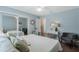Light-filled bedroom featuring a metal bed frame, walk-in closet, and light blue walls at 1188 Brampton Pl, Lake Mary, FL 32746
