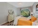 Comfortable bedroom with a large window, hardwood floors, and a dresser at 1188 Brampton Pl, Lake Mary, FL 32746