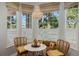 Cozy breakfast nook with natural light, charming chandelier, wicker chairs and views of the outdoors at 1188 Brampton Pl, Lake Mary, FL 32746