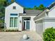 Charming home featuring gray roofing, a gray front door, an attached garage, and landscaped front yard at 1188 Brampton Pl, Lake Mary, FL 32746