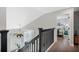 Hallway featuring hardwood floors and an open view to the entryway and a bedroom at 1188 Brampton Pl, Lake Mary, FL 32746