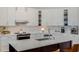 Modern kitchen with white cabinets, stainless steel appliances, and quartz countertops at 1188 Brampton Pl, Lake Mary, FL 32746