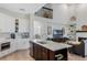 Bright kitchen featuring a large island, quartz countertops, stainless steel appliances, and ample storage at 1188 Brampton Pl, Lake Mary, FL 32746