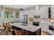 Modern kitchen boasts a spacious island, stainless steel appliances, and sleek white cabinetry at 1188 Brampton Pl, Lake Mary, FL 32746