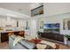 Open-concept living room with vaulted ceilings, hardwood floors, large TV, and seamless kitchen access at 1188 Brampton Pl, Lake Mary, FL 32746