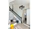 Elegant staircase with black banister and white risers, complemented by an entryway table at 1188 Brampton Pl, Lake Mary, FL 32746
