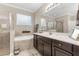 Bright bathroom featuring a tub, shower, and dark wood cabinetry at 12002 Angle Pond Ave, Windermere, FL 34786