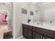 Bathroom featuring a vanity with framed art on the wall and a glimpse into an adjacent room at 12002 Angle Pond Ave, Windermere, FL 34786