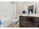 Clean bathroom featuring a shower-tub combination and a dark wood vanity with double sinks at 12002 Angle Pond Ave, Windermere, FL 34786