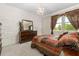 Beautiful bedroom featuring a decorative wall, chandelier lighting, and a large window with elegant curtains at 12002 Angle Pond Ave, Windermere, FL 34786