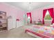 Bright bedroom with colorful decor, featuring a chandelier and natural light from windows at 12002 Angle Pond Ave, Windermere, FL 34786
