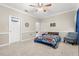 Cozy bedroom with carpet, a car-themed bedspread, and a basketball hoop on the door at 12002 Angle Pond Ave, Windermere, FL 34786