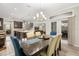 Bright dining room with chandelier, view to kitchen, and french door to the outside at 12002 Angle Pond Ave, Windermere, FL 34786