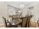 Refined dining room with stylish chandelier, view into the living room, and seating for eight at 12002 Angle Pond Ave, Windermere, FL 34786