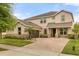 Charming two-story home featuring a brick driveway, stone accents and meticulously landscaped front yard at 12002 Angle Pond Ave, Windermere, FL 34786
