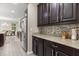 Modern kitchen featuring granite countertops, stainless steel appliances, and dark wood cabinets at 12002 Angle Pond Ave, Windermere, FL 34786