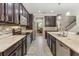 Stylish kitchen featuring stainless steel appliances, sleek countertops, and dark-wood cabinets at 12002 Angle Pond Ave, Windermere, FL 34786