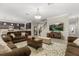Open-concept living room featuring dark wood kitchen cabinets and island with breakfast bar seating at 12002 Angle Pond Ave, Windermere, FL 34786