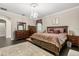 Spacious main bedroom with decorative chandelier, dark wood floors and area rug at 12002 Angle Pond Ave, Windermere, FL 34786
