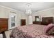 Main bedroom featuring an ornate chandelier, dark wood floors and furnishings at 12002 Angle Pond Ave, Windermere, FL 34786