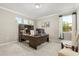 Well-lit home office with a large desk, built-in storage, and natural light from the windows at 12002 Angle Pond Ave, Windermere, FL 34786