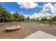 Community playground with swings, slides, and a roundabout, set in a safe, mulched area at 12002 Angle Pond Ave, Windermere, FL 34786