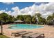 Community pool area with lounge chairs, gazebo, and meticulously maintained landscaping at 12002 Angle Pond Ave, Windermere, FL 34786