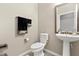 Powder room featuring a pedestal sink and modern fixtures at 12002 Angle Pond Ave, Windermere, FL 34786