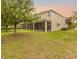 A spacious screened lanai provides ample outdoor living space in the home's backyard at 12002 Angle Pond Ave, Windermere, FL 34786