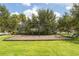 Community swing set with playground and bench surrounded by green grass at 12002 Angle Pond Ave, Windermere, FL 34786