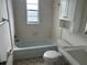 Bright bathroom features a bathtub with shower, toilet, vanity, and medicine cabinet at 1328 Highland Cir, Kissimmee, FL 34744