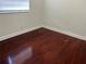 This bedroom features hardwood flooring, natural light, and neutral walls at 1328 Highland Cir, Kissimmee, FL 34744