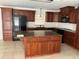 Spacious kitchen features wood cabinets, granite countertops, stainless steel appliances, and an island at 1328 Highland Cir, Kissimmee, FL 34744