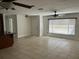 Bright living room showcasing tile flooring, a ceiling fan, and natural light from a large window at 1328 Highland Cir, Kissimmee, FL 34744