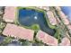 Aerial view of yellow buildings surrounding a lake with green landscaping at 1400 Lake Shadow Cir # 10105, Maitland, FL 32751